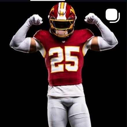 Nick Cross flexing in his Washington Commanders number 25 uniform
